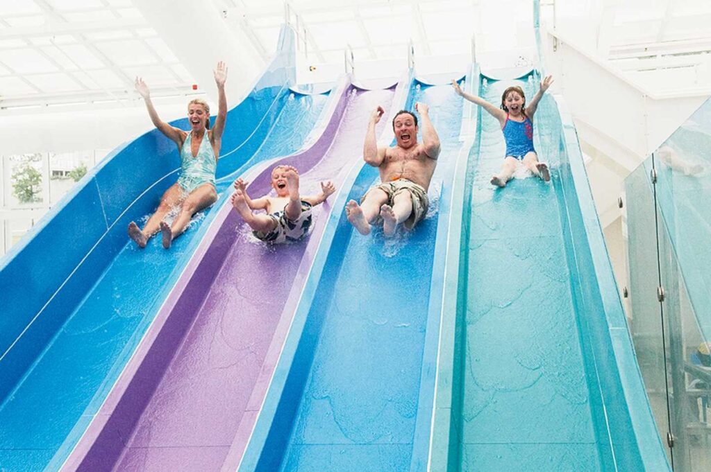 Family enjoying Devon Cliffs holiday park giant indoor pool