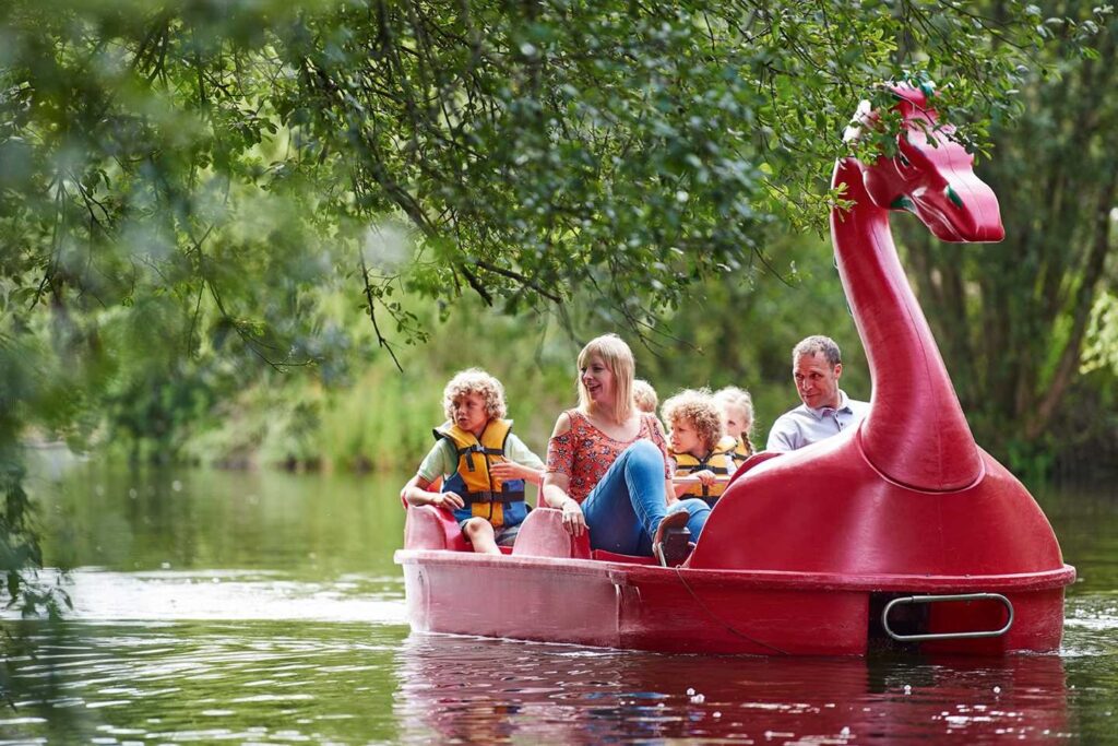 A family riding a dragon-shaped boat on the lake!