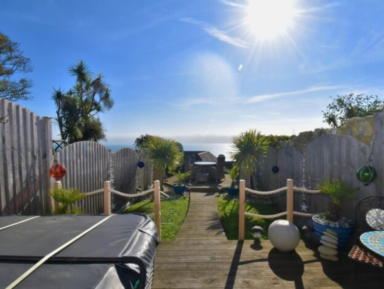 In Ventnor the hot tub sits in a coastal garden with sea views